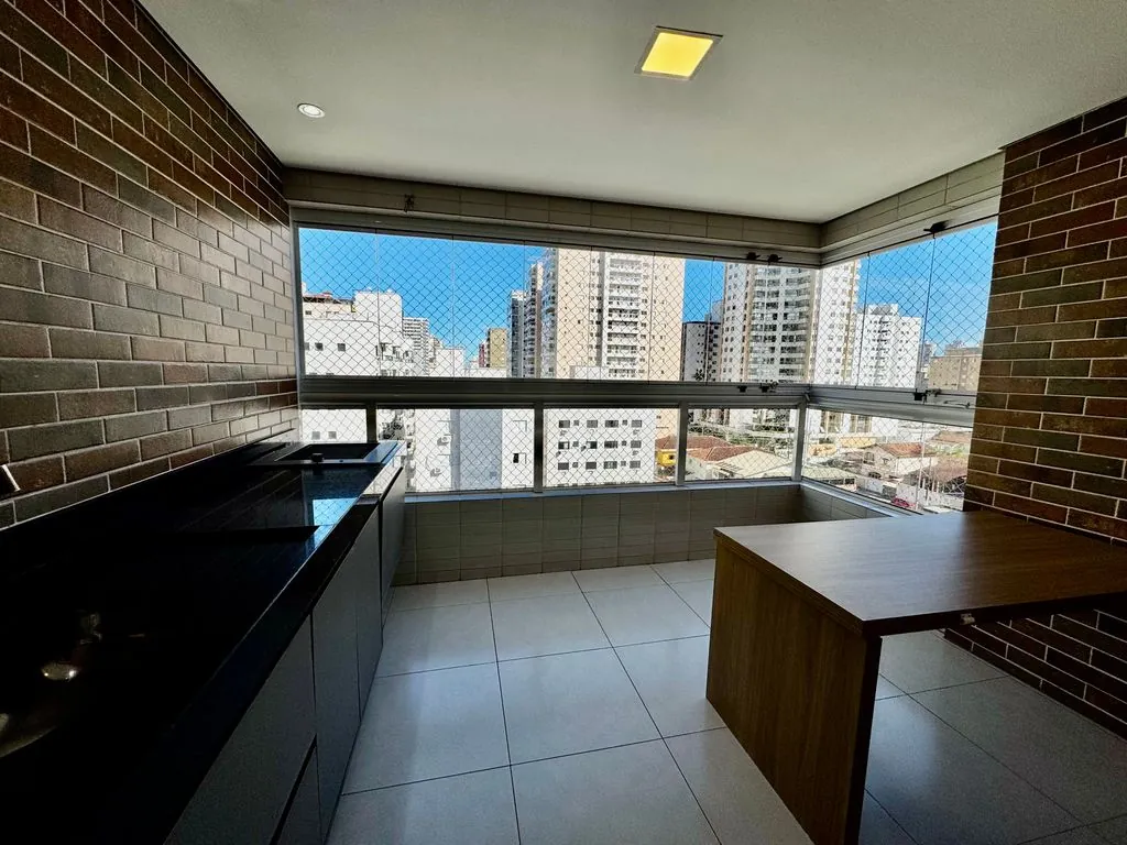 Ampla varanda gourmet envidraçada com churrasqueira e acesso a sala 2 ambientes
